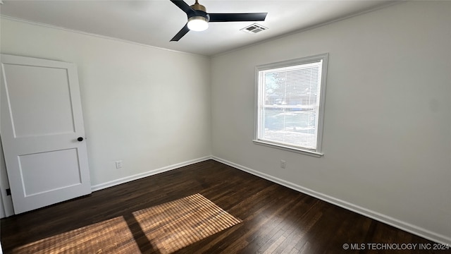 spare room featuring ceiling fan and dark wood-type flooring