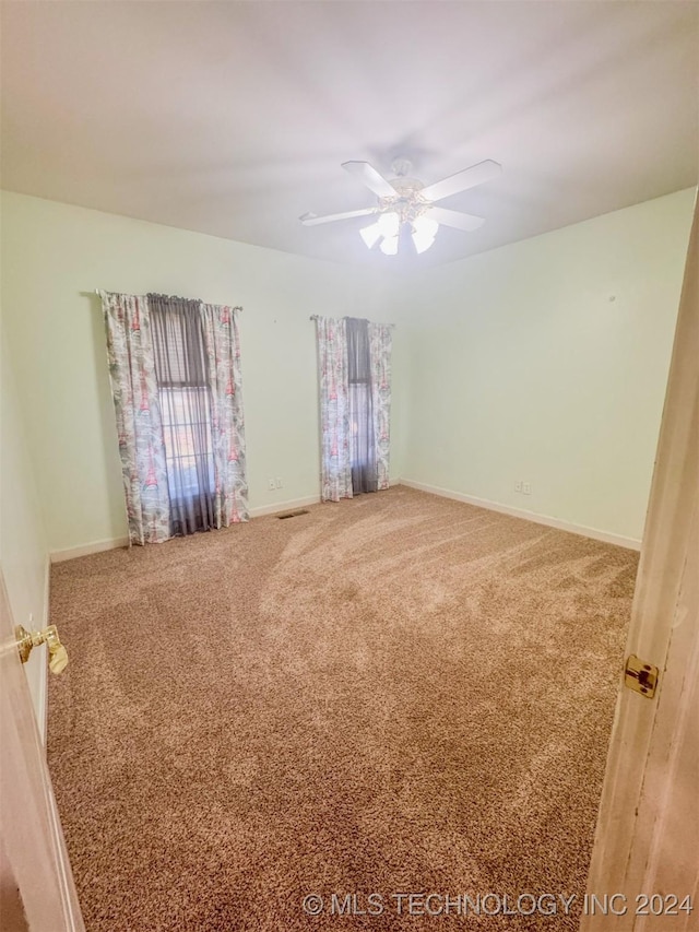 carpeted empty room with ceiling fan