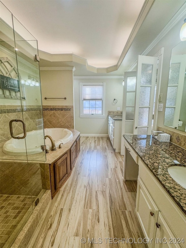 bathroom featuring shower with separate bathtub, vanity, ornamental molding, and wood-type flooring