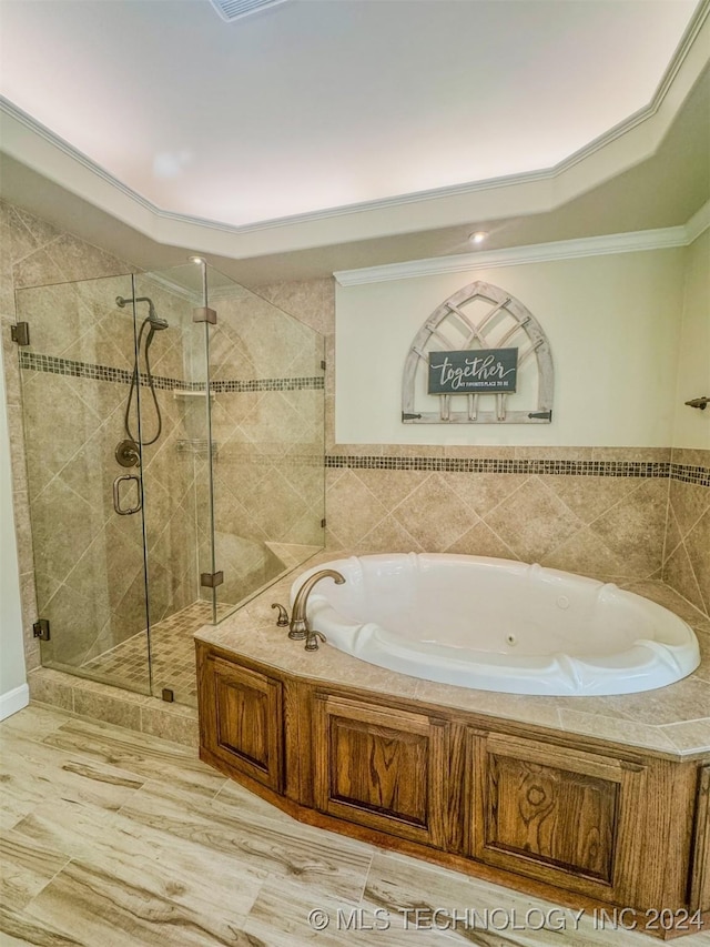 bathroom featuring ornamental molding and independent shower and bath