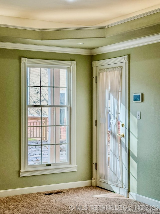 doorway with carpet and crown molding