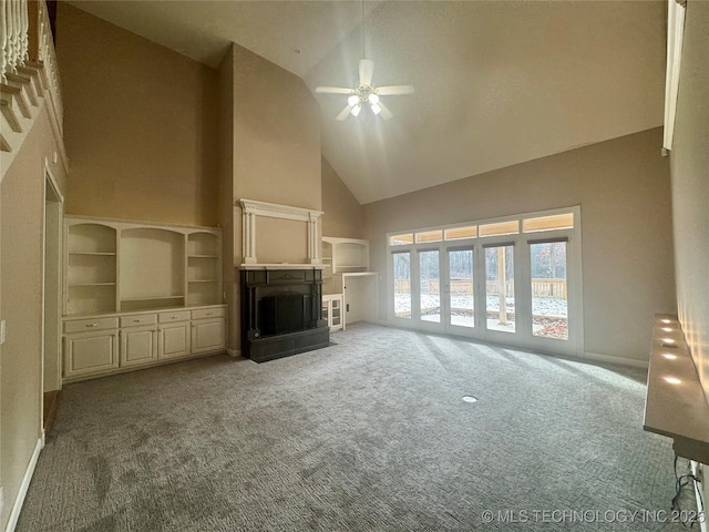 unfurnished living room with carpet, high vaulted ceiling, and ceiling fan