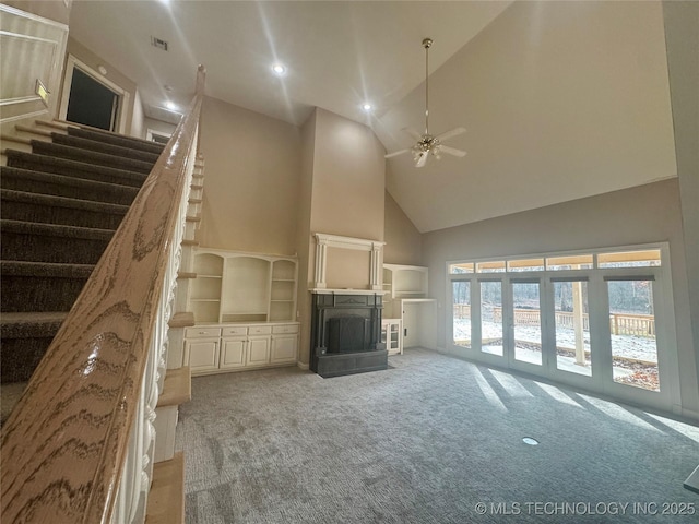 unfurnished living room with ceiling fan, light carpet, and high vaulted ceiling