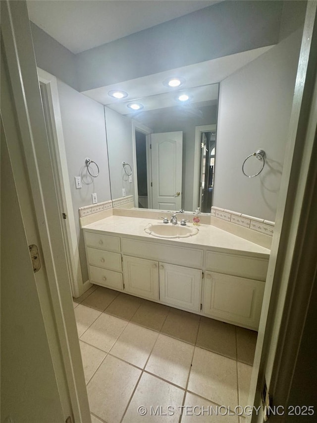 bathroom with tile patterned floors and vanity