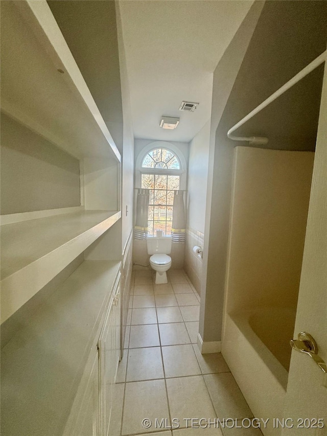 bathroom with tile patterned floors and toilet