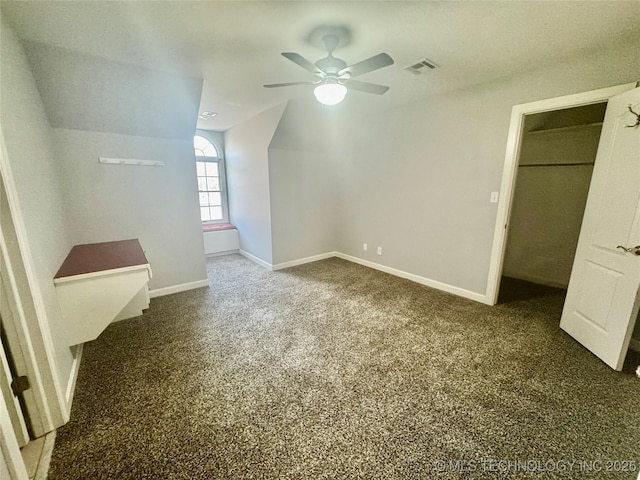 additional living space featuring ceiling fan, dark carpet, and lofted ceiling