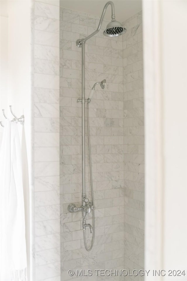 bathroom with tiled shower