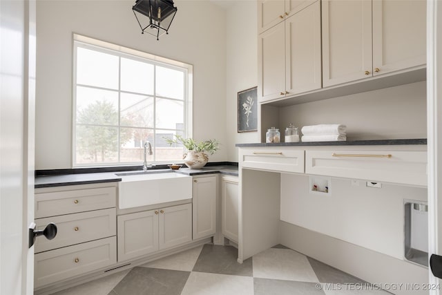 laundry room with sink, cabinets, and washer hookup