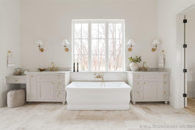 bathroom with vanity and a tub to relax in