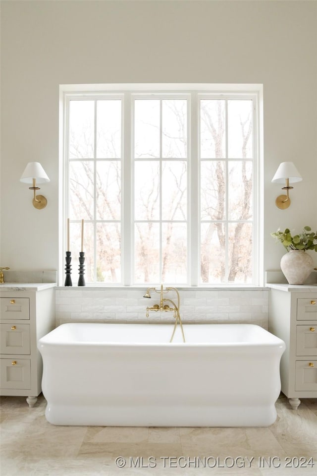 bathroom with a tub to relax in