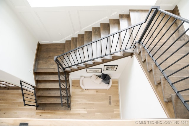 stairs featuring hardwood / wood-style floors