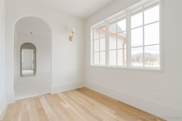 unfurnished room with hardwood / wood-style floors