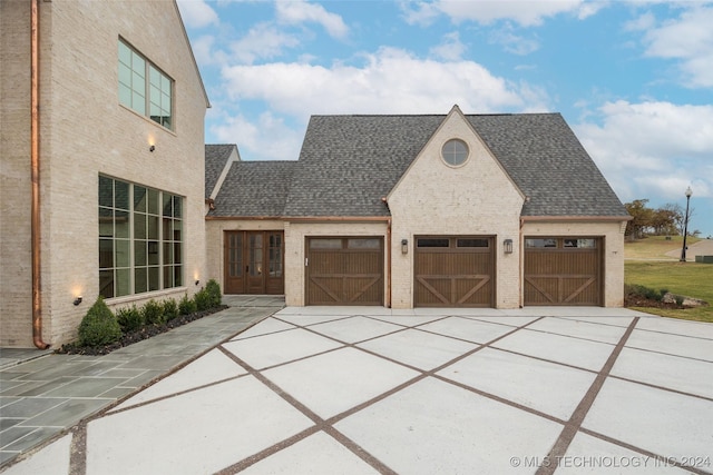 exterior space featuring french doors and a garage