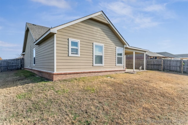 rear view of property featuring a yard