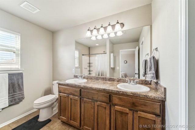 bathroom with a shower with shower curtain, tile patterned floors, vanity, and toilet