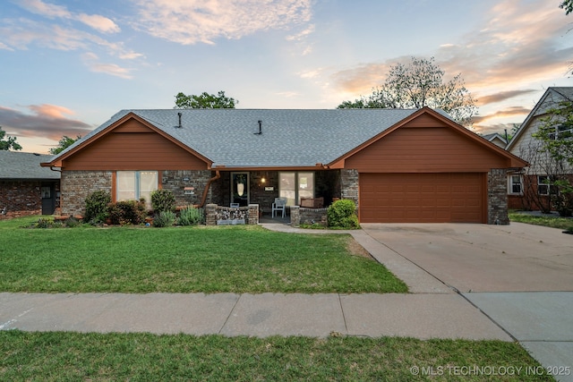 single story home with a garage and a lawn