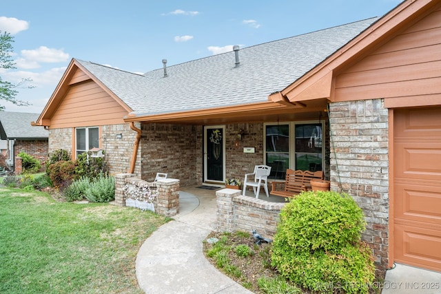 view of front of property with a garage, covered porch, and a front lawn