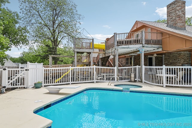 view of pool with an in ground hot tub and a patio