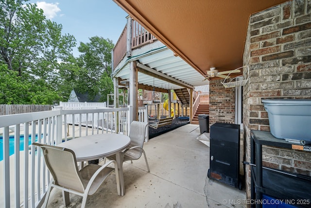 view of patio featuring a balcony, a pool, and ceiling fan