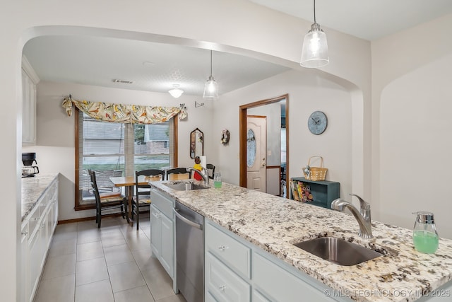 kitchen with dishwasher, sink, white cabinets, and decorative light fixtures