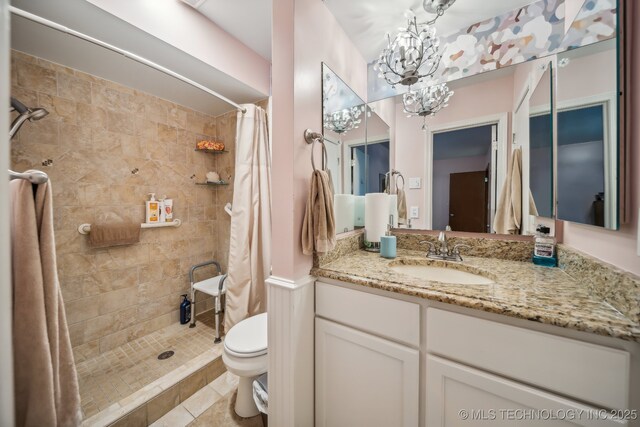 bathroom with vanity, an inviting chandelier, tile patterned flooring, toilet, and curtained shower