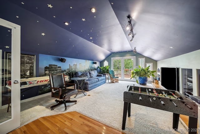 recreation room with lofted ceiling, wood-type flooring, and french doors