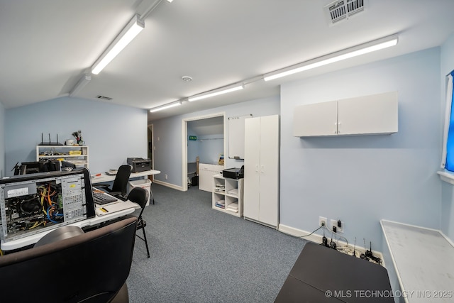 home office with dark carpet and lofted ceiling