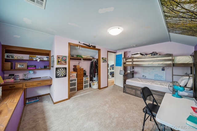 bedroom featuring a closet, light colored carpet, and lofted ceiling