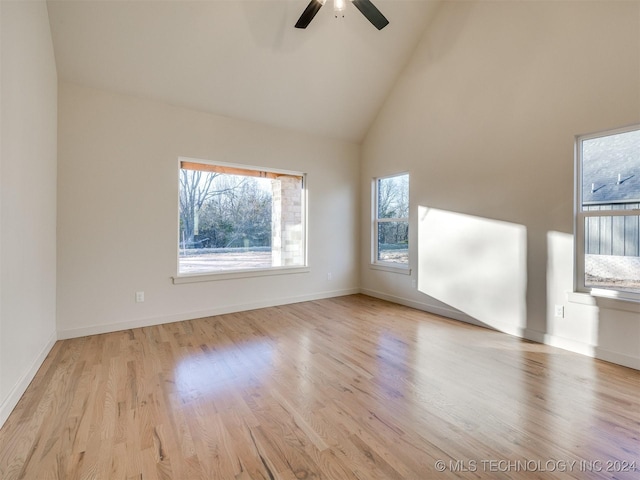 spare room with ceiling fan, high vaulted ceiling, and light hardwood / wood-style floors