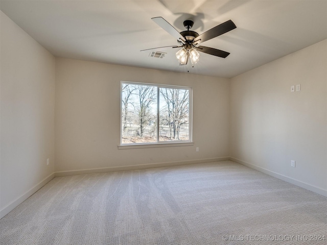 carpeted spare room with ceiling fan