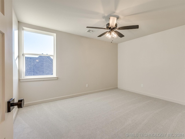 spare room with visible vents, ceiling fan, baseboards, and carpet