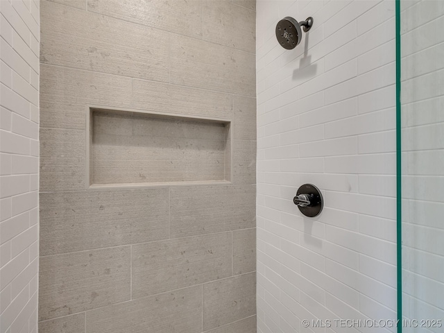 interior details featuring a tile shower