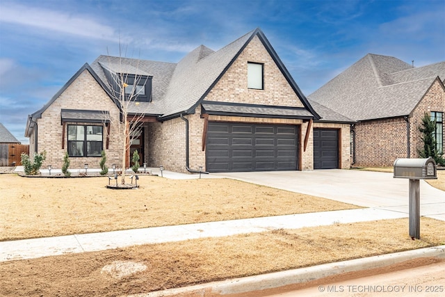 view of front of home with a garage, driveway, brick siding, and roof with shingles