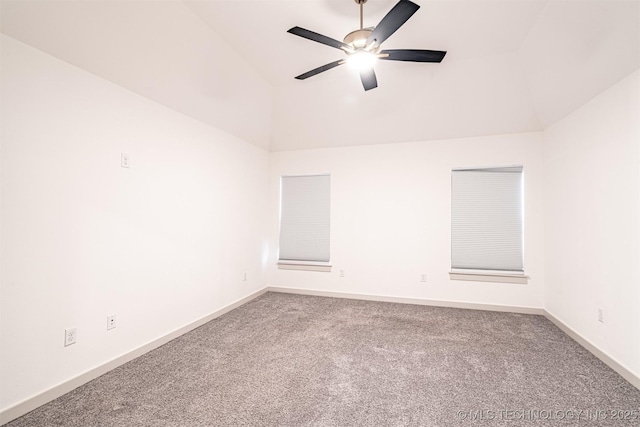 unfurnished room with carpet floors, baseboards, vaulted ceiling, and a ceiling fan