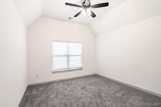 carpeted empty room featuring vaulted ceiling, a ceiling fan, visible vents, and baseboards