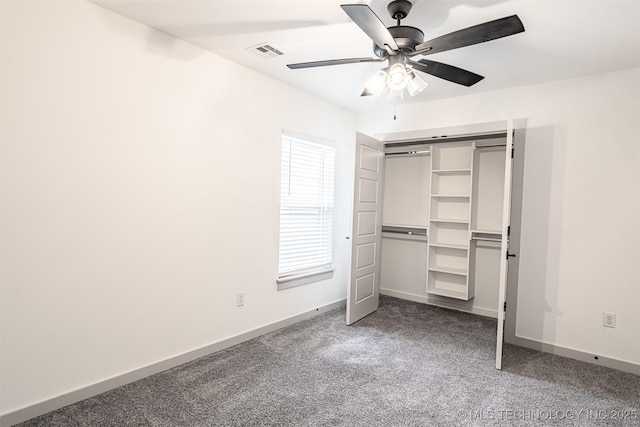 unfurnished bedroom featuring a closet, visible vents, a ceiling fan, carpet flooring, and baseboards