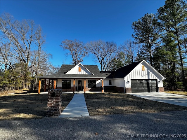 modern farmhouse style home with covered porch and a garage