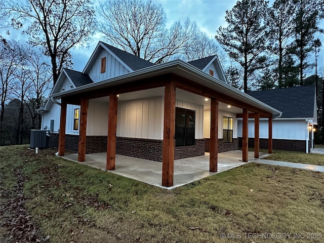 view of property exterior with central AC unit, a patio area, and a lawn