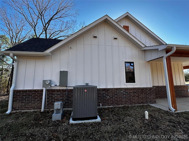 view of side of home with central AC unit