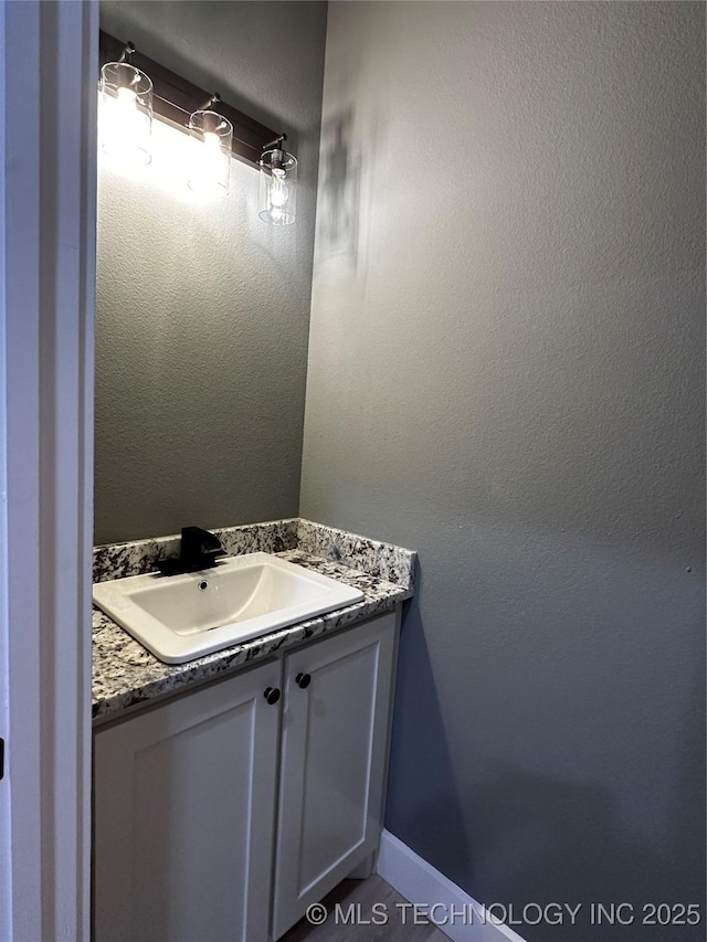 bathroom featuring tile patterned flooring and vanity