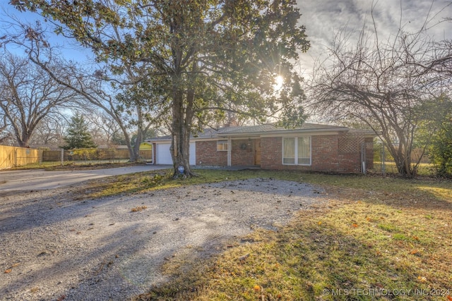 ranch-style home with a front yard and a garage