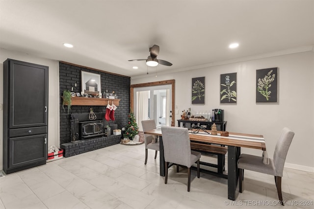 dining area with ceiling fan, a wood stove, and ornamental molding