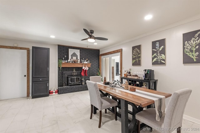 dining space featuring ceiling fan, a wood stove, and crown molding