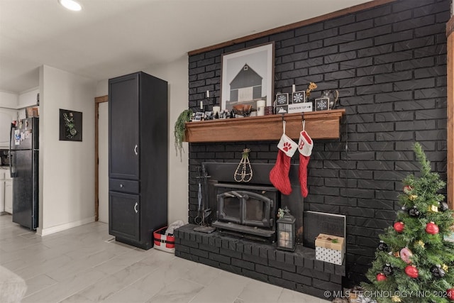 room details with black fridge and a wood stove