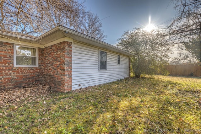 view of side of home featuring a lawn