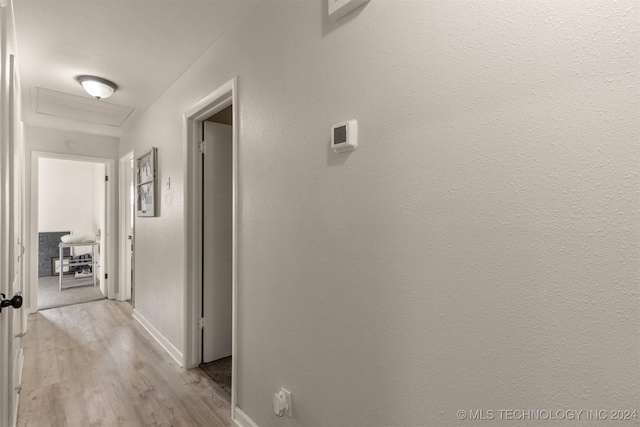 corridor with light wood-type flooring