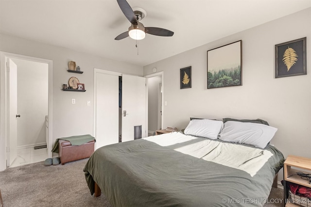 bedroom with ceiling fan and light carpet