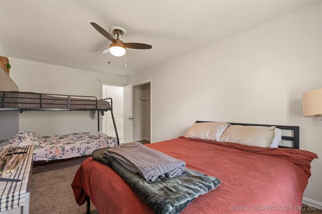 carpeted bedroom featuring ceiling fan and a closet