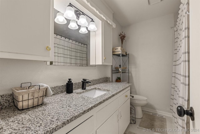 bathroom featuring vanity and toilet