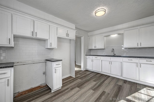 kitchen featuring sink, white cabinets, and a textured ceiling